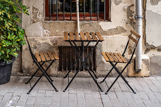 istock Empty Wooden Bistro Table and Chairs on Sidewalk 2253399619