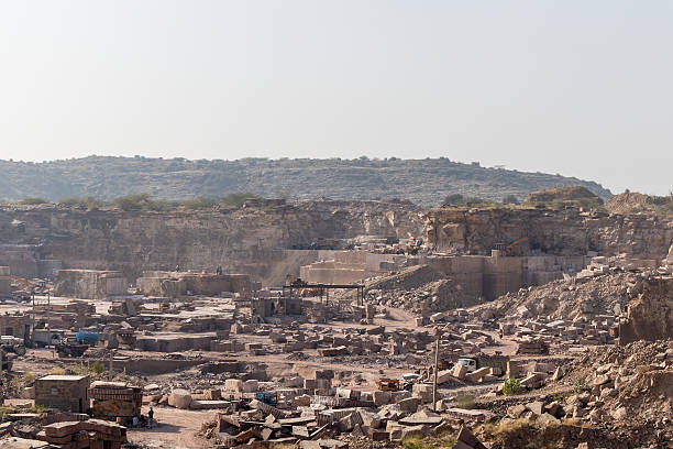 istock industrial mining operations in large rock quarry under bright daylight in Aravalli range 2253400979