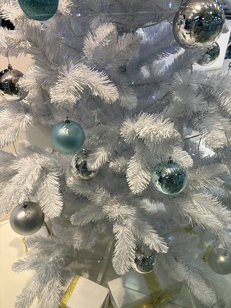 istock Delicate beautiful Christmas decorations on a white artificial new year tree 2253402797