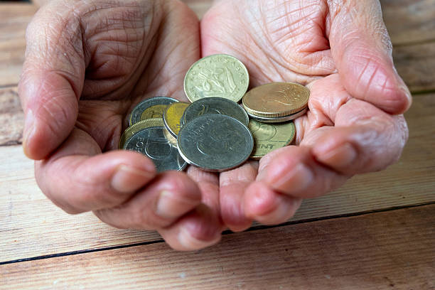 istock Elderly Hands Holding Limited Savings 2253403864