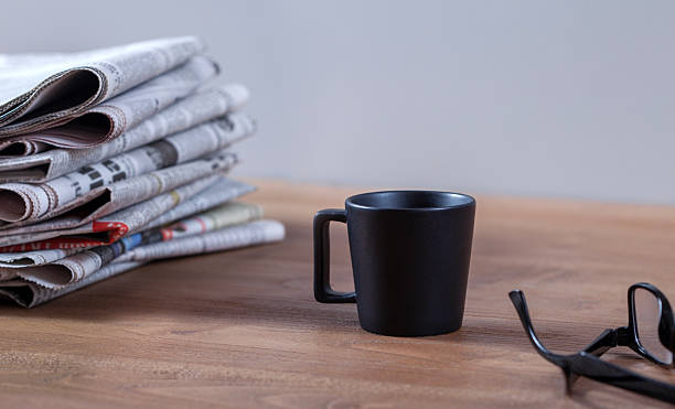istock newspaper and coffee on office table 2253403967