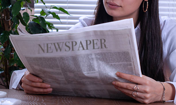 istock woman reading newspaper 2253403998