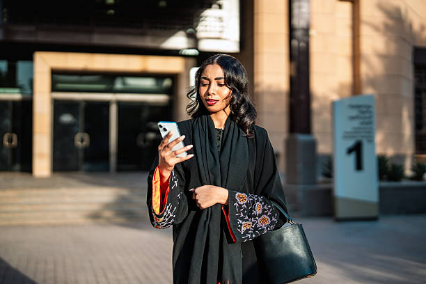 istock Young Arab Woman Interacting with Smartphone on Riyadh Campus 2253406611