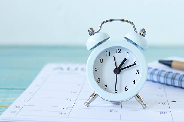 istock Alarm clock, calendar, and notebook with white background 2253412699