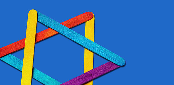 istock Creative abstract arrangement of rainbow-colored wooden sticks forms an intriguing. 2253413363