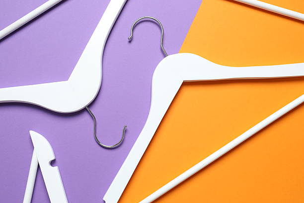 istock Wooden clothes hangers on a colored background 2253413599