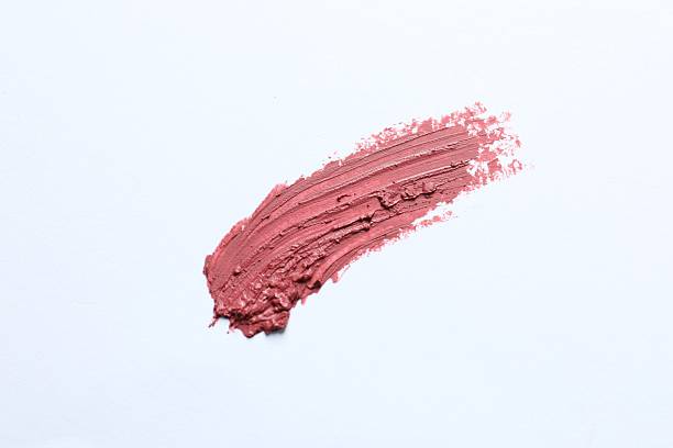 istock Smear of beautiful lipstick on white background, top view 2253413977