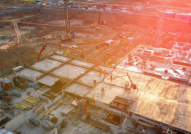 istock Formwork on construction site. Heavy machinery, crane on formworks. Concrete boom pump arm, drone view. 2253413995