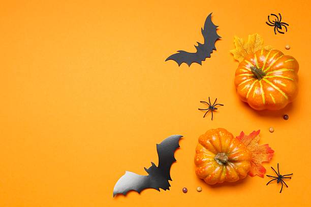 istock Halloween holiday decorations including pumpkins, spiders, bats on orange background 2253414538