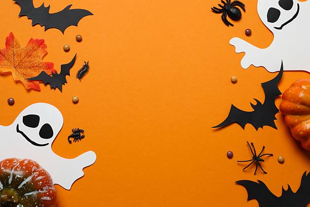istock Halloween holiday decorations including pumpkins, spiders, ghost and bats on orange background 2253414566