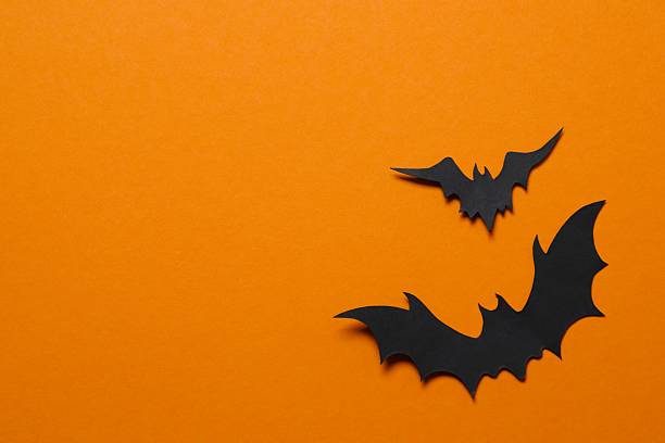 istock Black bats on orange background. Halloween concept 2253414572
