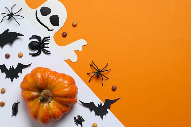 istock Halloween holiday decorations including pumpkins, spiders, ghost and bats on orange background 2253414584