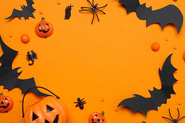 istock Halloween holiday decorations including pumpkins, spiders, bats on orange background 2253414682