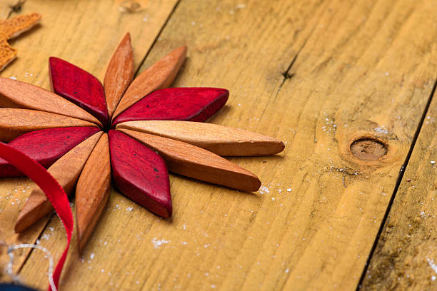 Red and brown wooden star decoration on rustic background with copy space