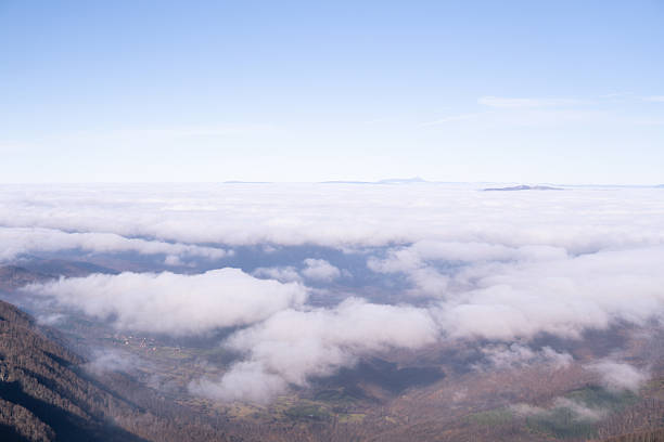 View above the clouds and valley bellow