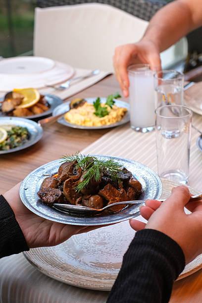 istock Hands Sharing Traditional Turkish Meze Dishes at a Restaurant Table 2253427853