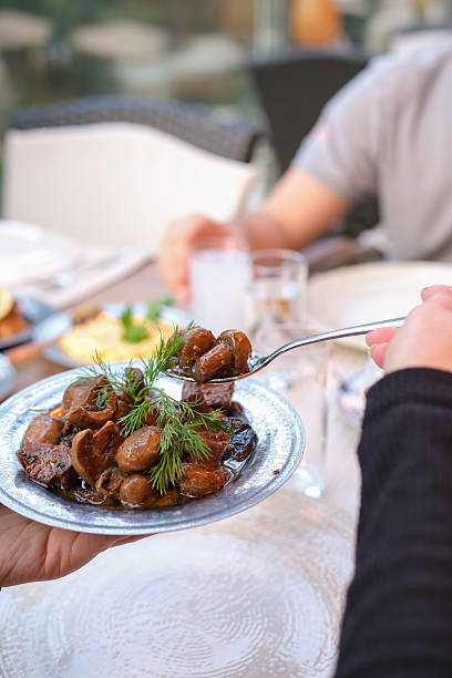 istock Hands Sharing Traditional Turkish Meze Dishes at a Restaurant Table 2253427854