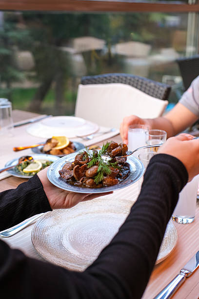 istock Hands Sharing Traditional Turkish Meze Dishes at a Restaurant Table 2253427856