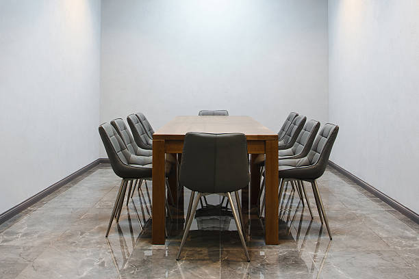 istock Modern conference room with a large wooden table and grey upholstered chairs. 2253432580