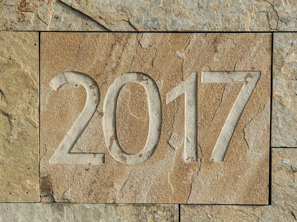istock Carving the year 2017 into rough natural stone 2253435059