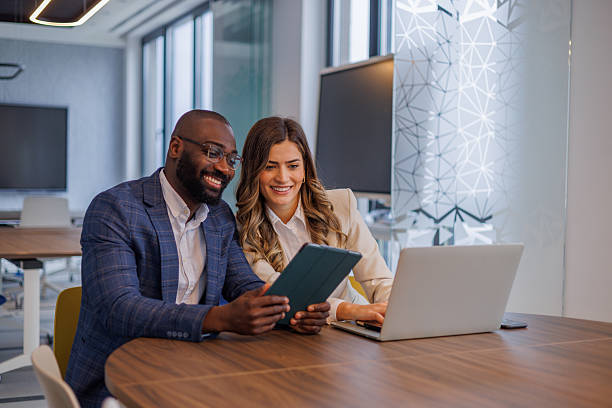 istock Diverse business professionals collaborating on digital tablet and laptop in modern office meeting 2253438543