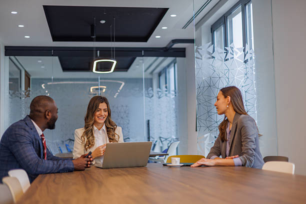 istock Business colleagues collaborating on laptop in modern office boardroom, discussing project strategy 2253439780