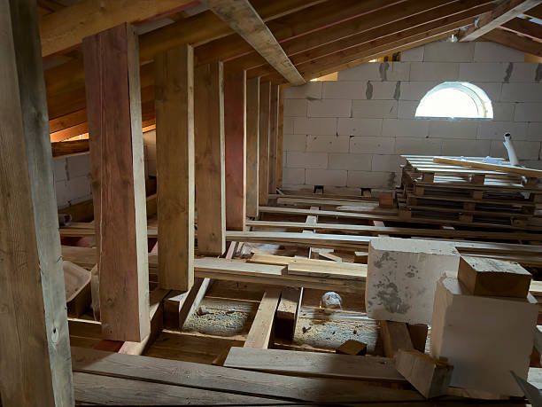 istock Workers are preparing the attic space with wooden beams and construction materials for a renovation 2253439980
