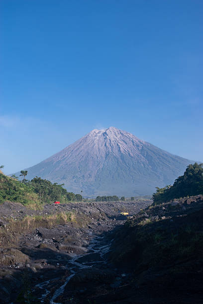 A stunning scene of Mount Semeru and rocky river.