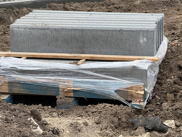 istock Workers prepare a site with concrete blocks placed on a pallet for building projects 2253441556