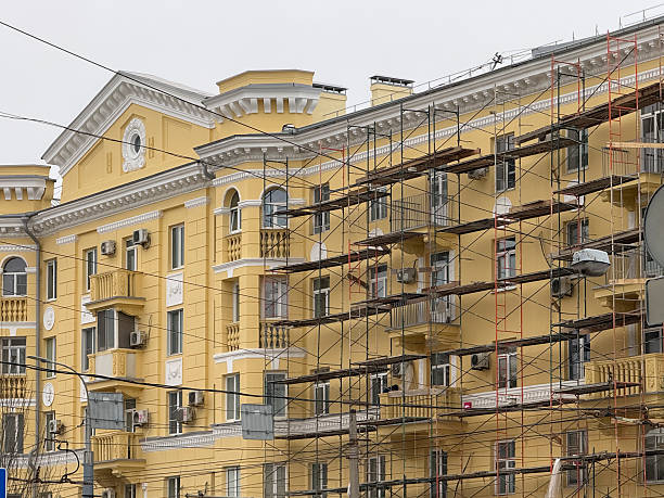 istock A building is under renovation with scaffolding. Construction workers are busy with their tasks 2253441697