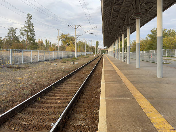 istock A train station shows empty platform and tracks with no people present at this time 2253442698