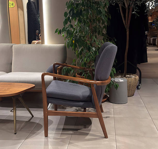 istock A chair sits near a table in a retail space with greenery around, showcasing simple design 2253442814