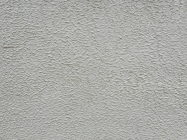 istock Close view of a textured wall showing patterns and shades in daylight, highlighting design 2253442877
