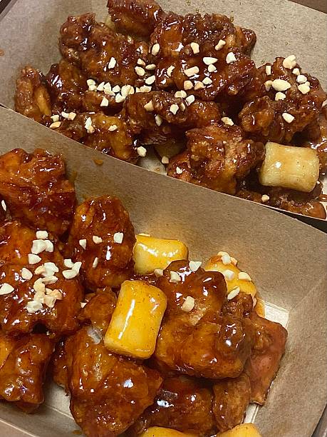 Crispy Korean fried chicken, perfectly glazed with a sweet and spicy sauce. Ideal for food photography and menus, showcasing the irresistible crunch and flavor of this beloved dish.