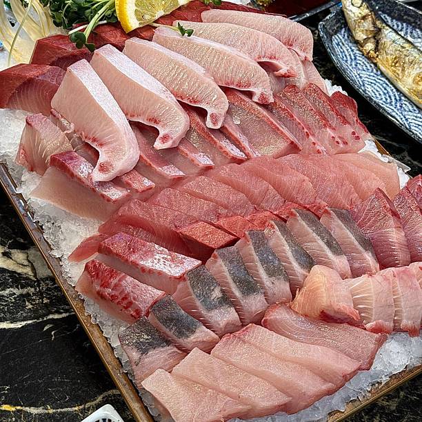 Fresh and delicate sashimi slices, beautifully presented with vibrant colors and perfect cuts. This traditional Japanese delicacy highlights the pure flavors of premium seafood.