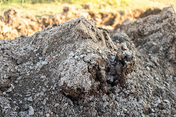 Soil bulk at that excavated at construction building site. Industrial working place, close-up and selective focus.