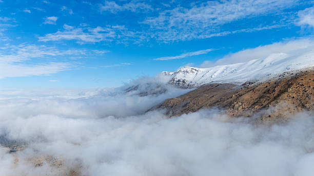Snowy Beydaglari Mountains above clouds in Antalya, Turkey