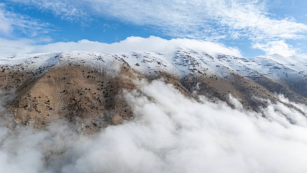 Snowy Beydaglari Mountains above clouds in Antalya, Turkey