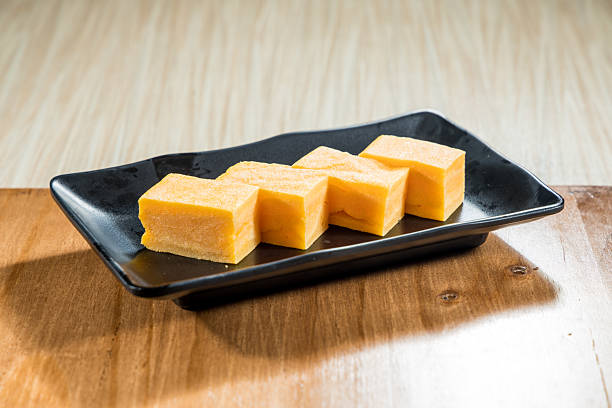 istock Japanese tamagoyaki egg slices on black plate 2253444245