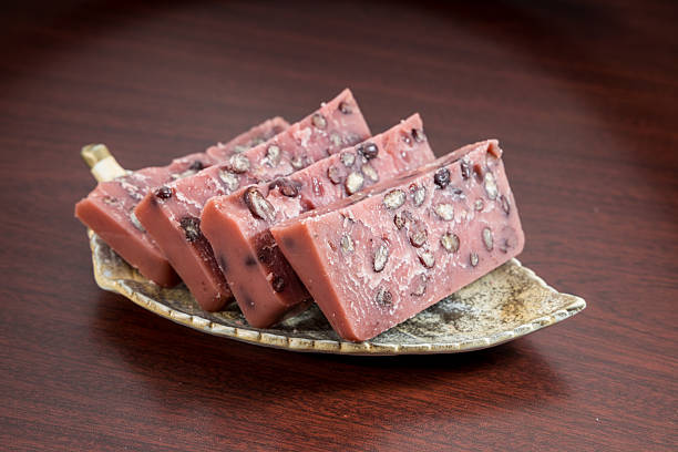 Slices of red bean dessert arranged on a ceramic plate, showcasing a sweet and chewy texture.