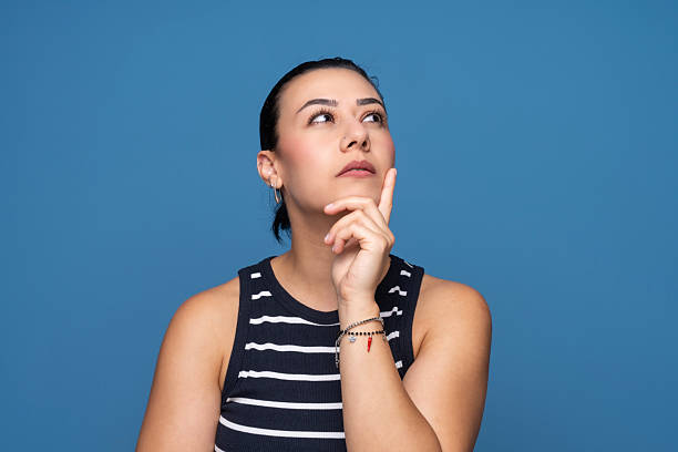istock Thoughtful Woman Looking Up  Contemplative Expression 2253444575