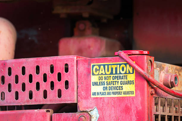 Caution alert sign of the machinery moving part, no hand for accident prevention. Industrial safety sign on the object, close-up.