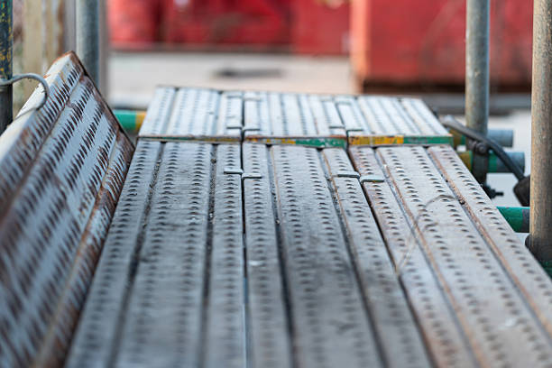 Scaffolding structure with metal floor plate. Industrial building and construction site workplace.