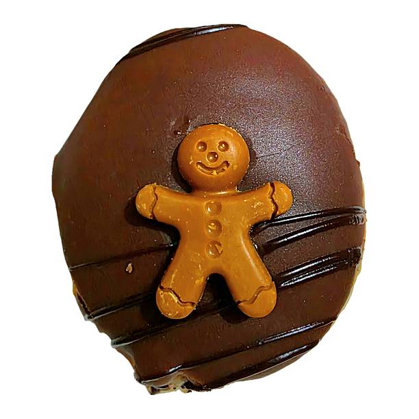A slightly burnt star-shaped gingerbread cookie in natural condition on a white background, captured in a close-up style.