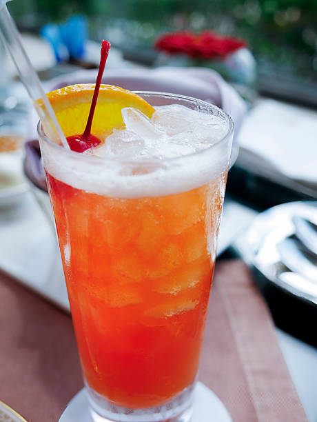 istock Refreshing Red Fruit Punch Cocktail with Orange Slice and Cherry Garnish, modern cafe style 2253446304