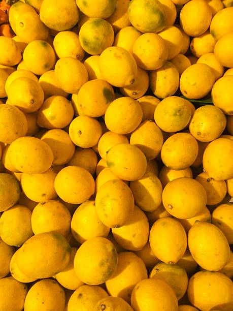 Extreme close up of a lemon slice on white background.