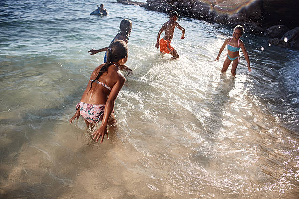 American boy frolics, bathes and swims in the sea. Plays in the spray of sea waves.