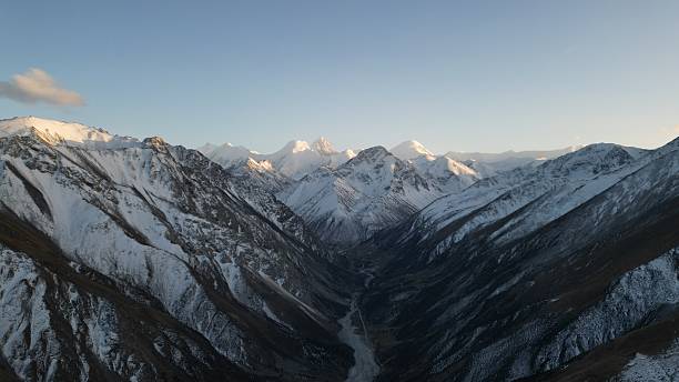 istock Majestic snow-capped mountains towering over deep valley landscape 2253450107