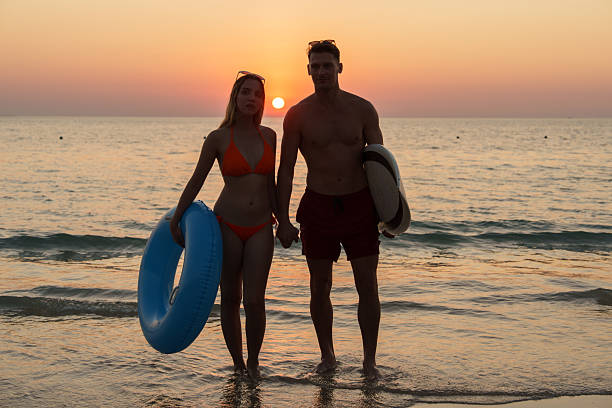 The couple enjoyed themselves on the beach at sunset.