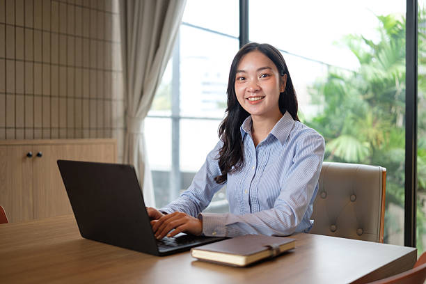 istock Confident businesswoman using laptop in modern office. 2253450417